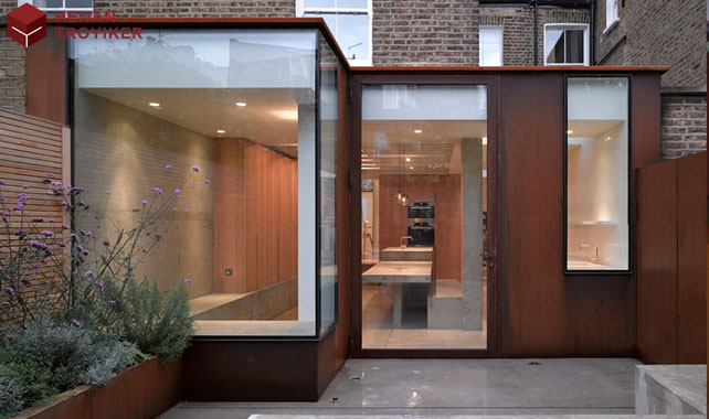 Corten steel and glass converged Victorian style house